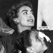 Summer 1956. Joan, Al, and twins look at Joan at London's Film Exhibition.