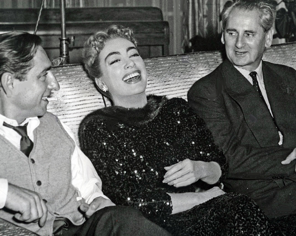 1957. On the set of 'Esther Costello' with director David Miller, left.