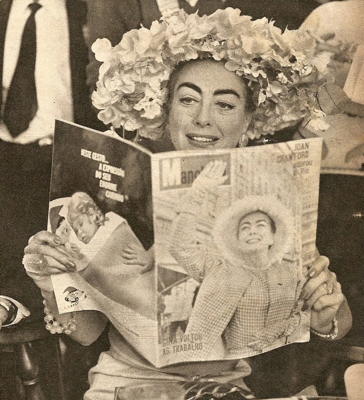 1960. Reading about herself in the July 1960 issue of Brazil's 'Manchete' magazine.