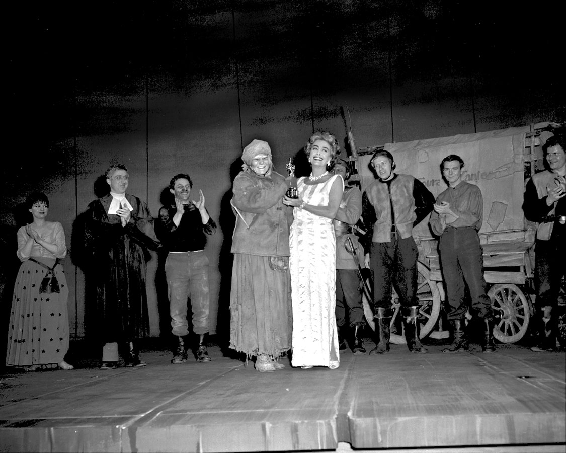 May 1963. Joan delivering Anne Bancroft's Oscar on the set of Broadway's 'Mother Courage.' (See if you can spot Gene Wilder in the cast.)