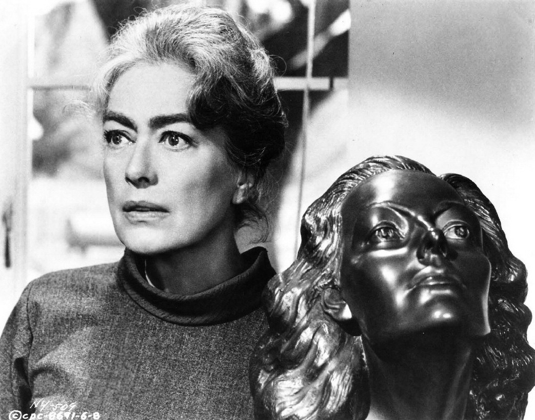 1964. 'Strait-Jacket.' With a sculpture of herself given to her in 1941 by Yucca Salamunich.