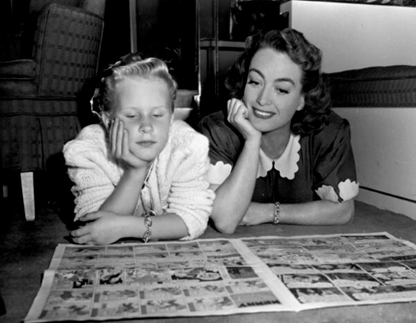 1947. On the set of 'Daisy Kenyon' with daughter Christina.