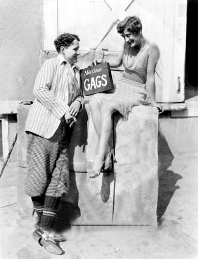 1928. With Charlie Chaplin on the set of 'Four Walls.'