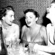 1952. Joan, Judy Garland, and Jane Wyman whoop it up at Romanoff's.