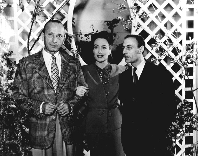 1945. On the set of 'Mildred Pierce,' with director Curtiz, left.