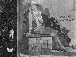 Harry Langdon admires Joan on a billboard in 'Tramp, Tramp, Tramp.'