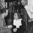 1935. On the set of 'I Live My Life.' With producer Bernard Hyman and director W. S. Van Dyke.