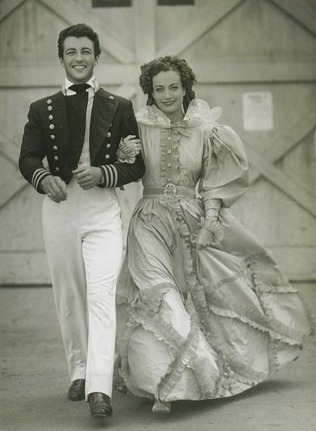 1936. On the set of 'Gorgeous Hussy,' with Robert Taylor. (Thanks to Shane.)