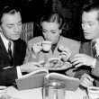 1937. On the set of 'The Last of Mrs. Cheyney' with William Powell, left, and Robert Montgomery.