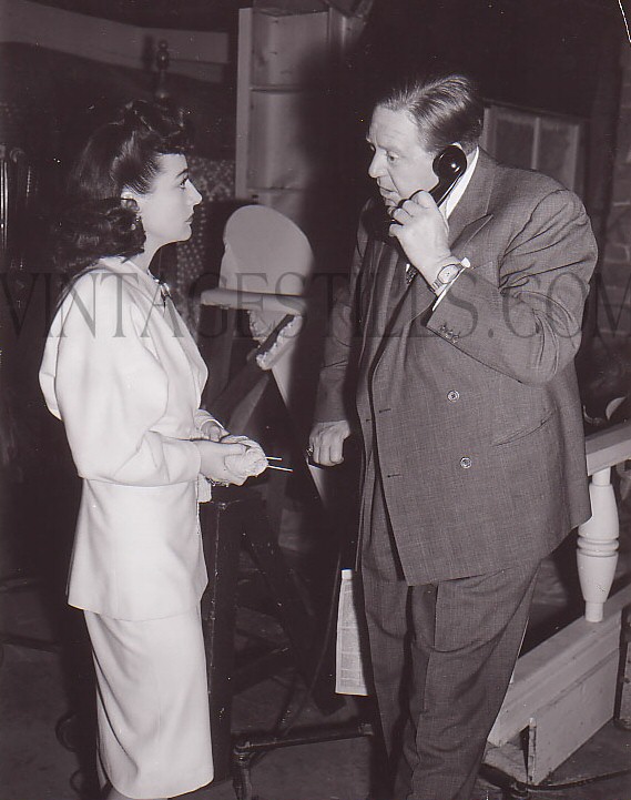 1941. On the set of 'When Ladies Meet' with director Robert Z. Leonard.