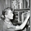 Circa 1950, at home with books.