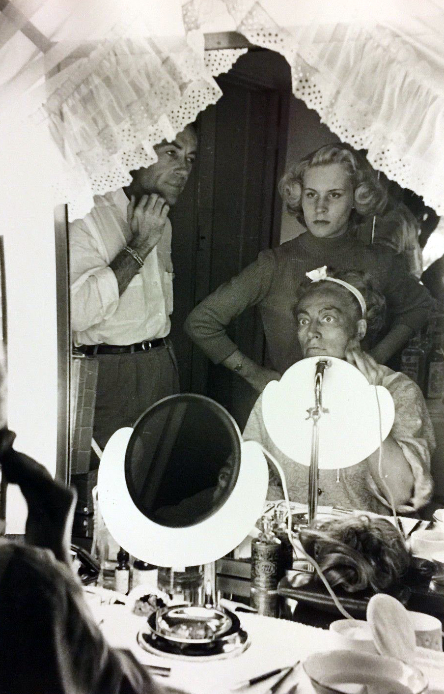 1953. Blackface on the set of 'Torch Song,' with director Walters and daughter Christina looking on.