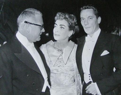 October 1956. With husband Al Steele and Peter Finch, after being presented to QEII. (Thanks to Susanne.)