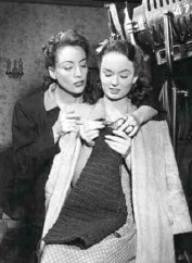 Joan helps Ann with her knitting on the set of 'Mildred Pierce.'