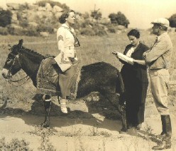 On the 'I Live My Life' set. From left: Joan, script girl Florence Thomas, Van Dyke.